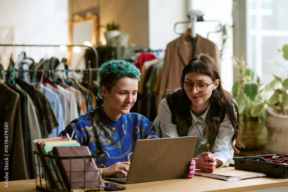 Charity retail team reviewing sales on a laptop